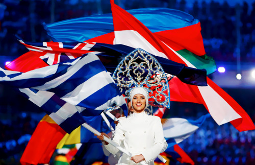 Flagbearers arrive holding their national flags in the closing ceremony for the Sochi 2014 Winter Ol