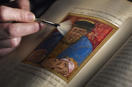 alfiusdebux: Conservator working on the original handwritten and hand-painted copy of Histoires Prod