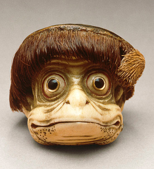 japaneseaesthetics:  ‘Netsuke’ (miniature sculptures that were invented in 17th-century Japan) in the form of a Kappa mask. Mid-to-late 19th century, Japan.  Stag antler (main) with hide (hair) and inlays (eyes).  LACMA (Raymond and Frances Bushell