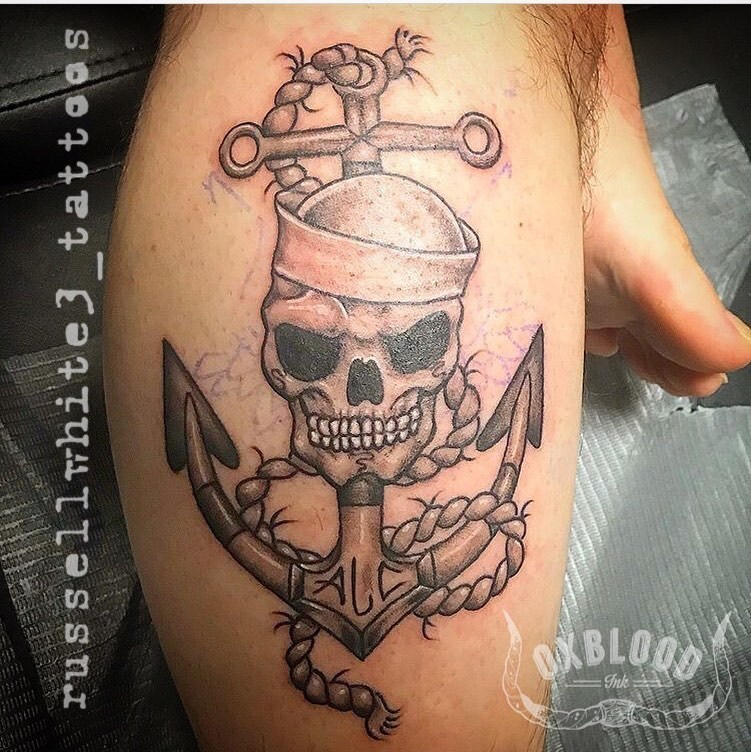 Tattoo logo with an anchor skull and wings behind Vector Image
