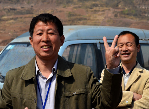 Chinese tourist flashing a peace sign during the Taihang Mountain trip near  Anyang, China.