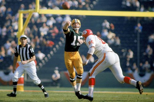 Green Bay Packers quarterback Bart Starr passes against Kansas City Chiefs defensive tackle Buck Buc