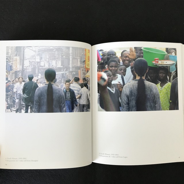 Page spread: Both images show the back of the artist in the crowded scenes somewhere outside. 
