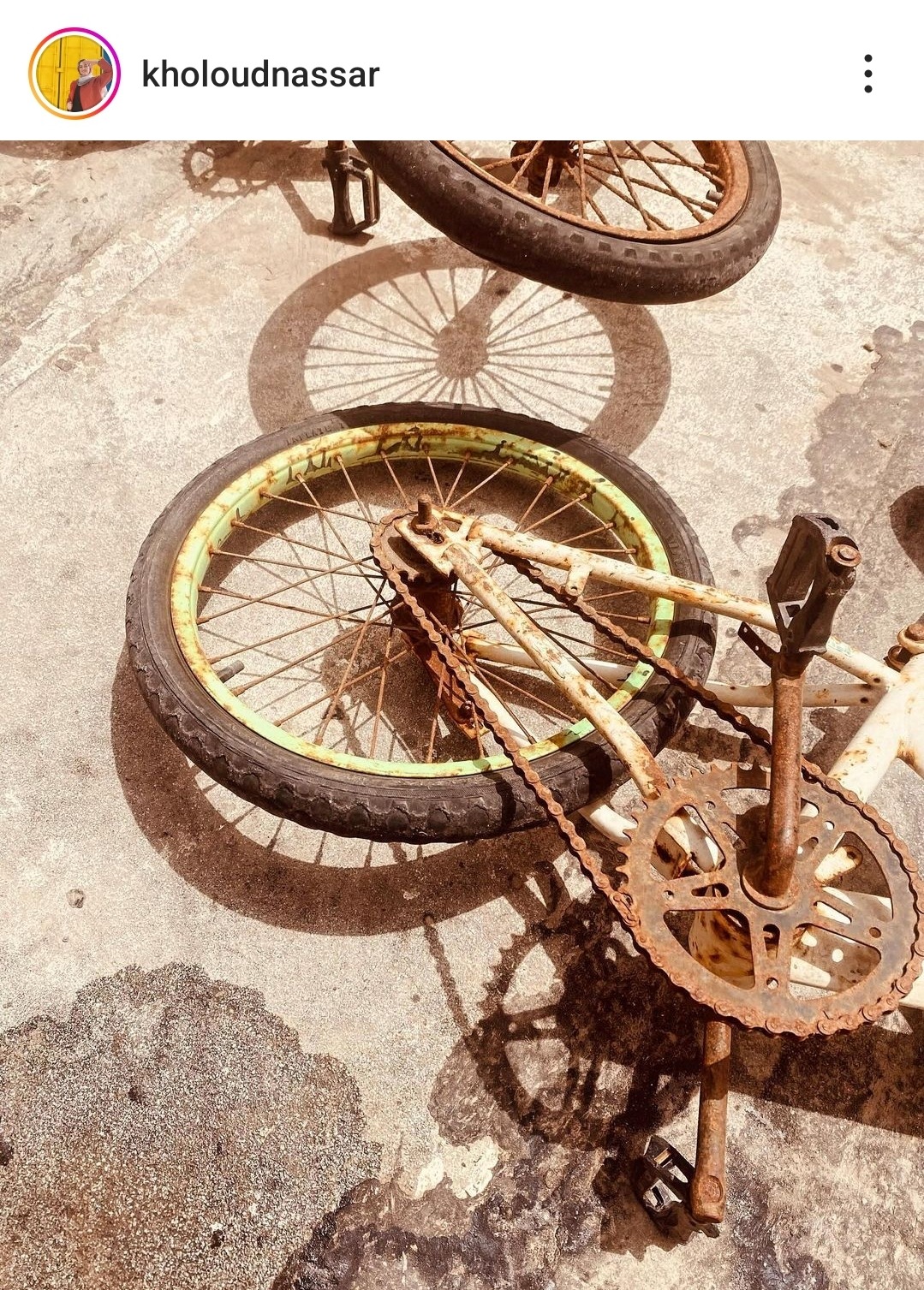A photo of two rusty bikes on the ground
