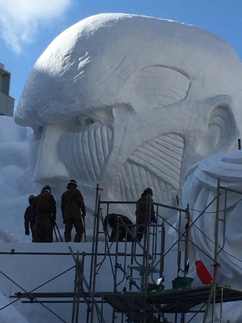 Close-ups of the Colossal Titan model and actual snow sculpture under construction,