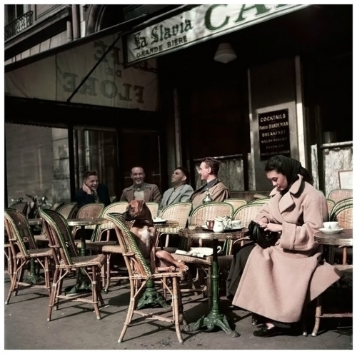 Alla and her dog sitting at Cafe de Flore,Paris, 1952. Photo by Robert Capa.