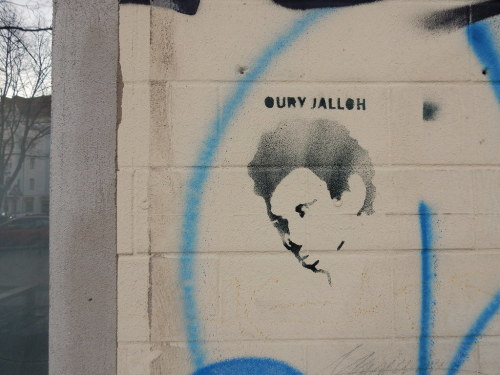 Memorial graffiti and posters across Germany for Oury Jalloh, a refugee from Sierra Leone who was bu
