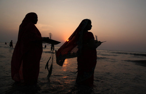 o-g-steve:awkwardsituationist:indian hindu devotees offer prayers to the sun in the arabian sea duri