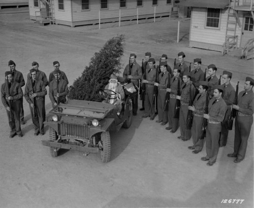 humanoidhistory:“Just before Santa Claus leaves his ‘jeep-sleigh’ the guard of honor stands on each 