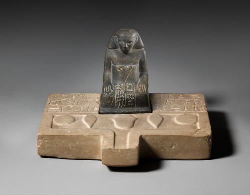 Ancient Egyptian limestone offering table with a greywacke statuette of a man named Sehetepib.  Arti