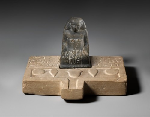 Limestone offering table with a greywacke statuette of Sehetepib.  Artist unknown; ca. 1850-1775 BCE