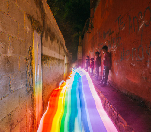 itscolossal:Vivid Rainbow Roads Trace Illuminated Pathways Across Forests and Beaches