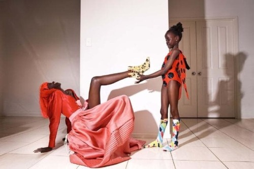 femmequeens:Adut Akech Bior with her family and friends photographed by Charlie Dennington for Vogue