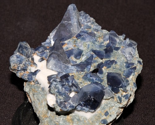 Benitoite crystals with a small crystal of black neptunite from the Dallas Gem Mine, San Benito Coun