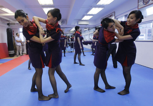 legsfan:Asian stewardess self-defense training in pantyhose and stocking feet.