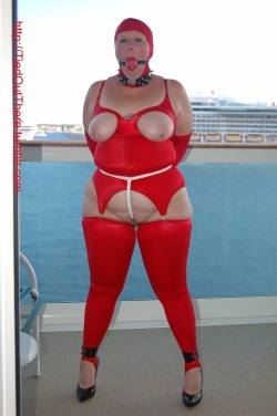 tiedoutthere:Polly on a cruise ship balcony in red spandex.