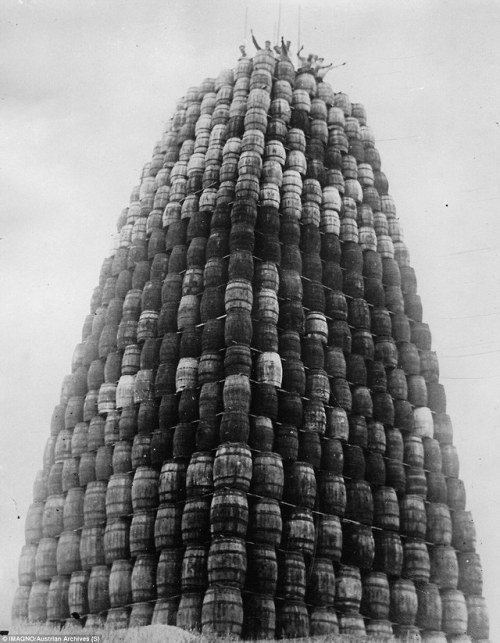 Workers wave from the top of a tower of confiscated alcohol in 1929 during the prohibition era. - St