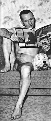 vintagemusclemen:  Middle aged fellow on couch with pup.