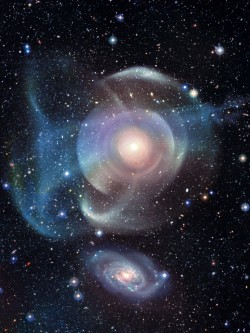 kenobi-wan-obi:   NGC 474  The multiple layers of emission appear strangely complex and unexpected given the relatively featureless appearance of the elliptical galaxy in less deep images. Image Copyright: Canada-France-Hawaii Telescope (Jean-Charles