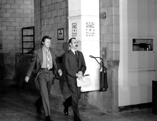 G. Gordon Liddy (right), handcuffed and in the custody of a U.S.Marshal, arrives at the Criminal Cou