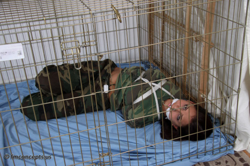 damselsandothersexyness:graybandanna:Military prisoner hogtied in a cageCali Logan serving our fine 
