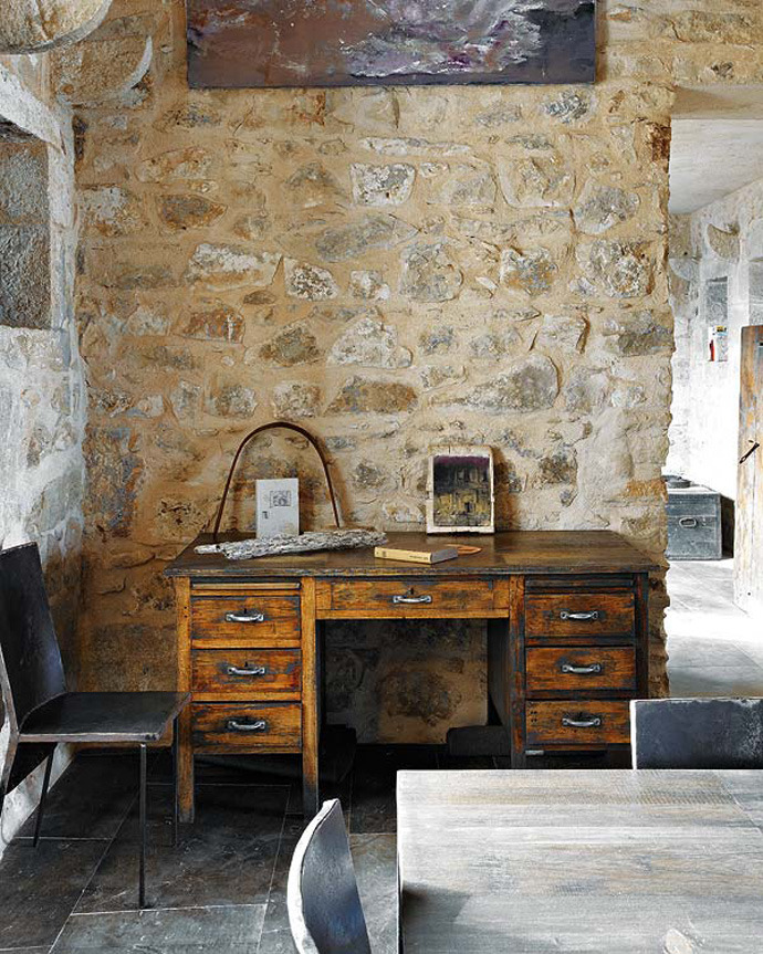 Rustic and minimalist workspace inside this old Sicilian house. Amazing stonework.