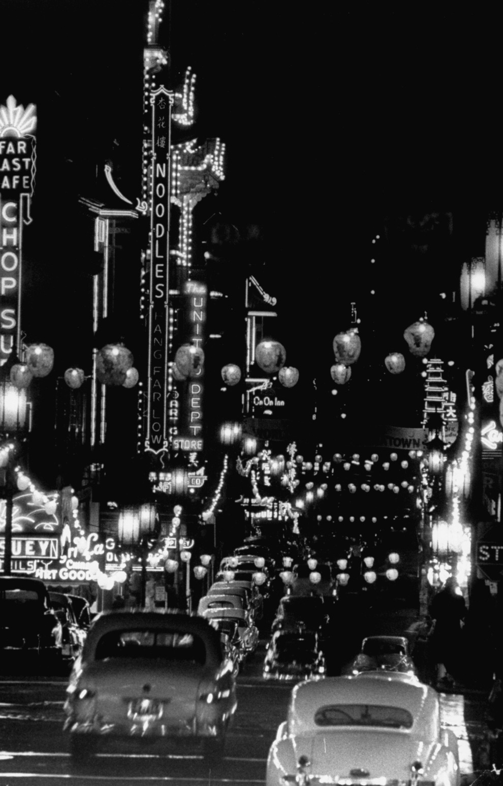 bygoneamericana:  Cars driving through Chinatown at night. San Francisco, circa 1950s.