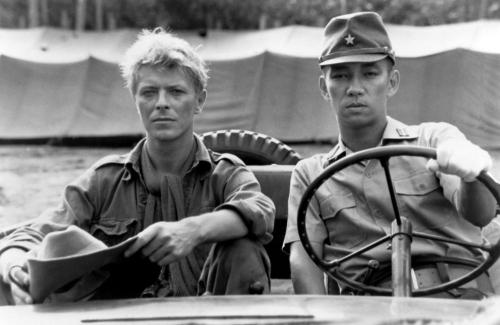 carsthatnevermadeit:David Bowie and Ryuichi Sakamoto in a Jeep in the 1983 movie Merry Christmas Mr 