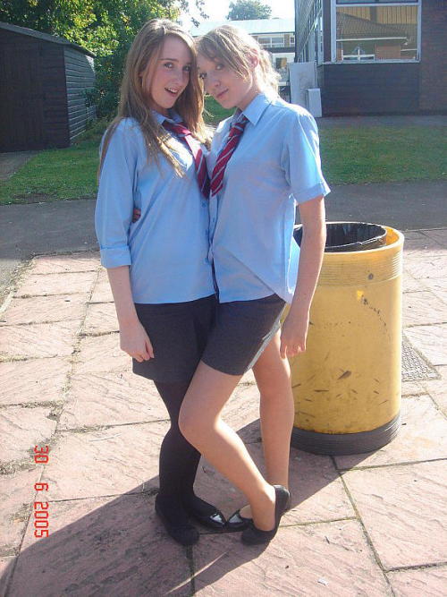 schooluniformpantyhose:  A girl wearing black tights poses with her friend who is wearing sheer pant
