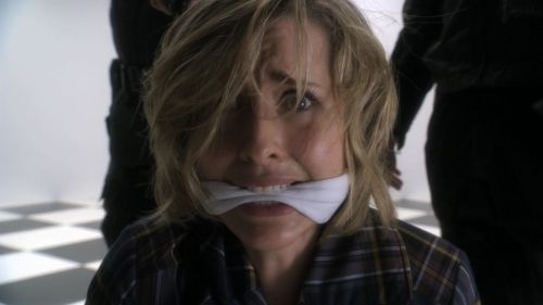 graybandanna:  Allison Mack hooded, cuffed and gagged on Smallville.  Interesting that after she is free, she keeps the handcuffs and handkerchief and walks them over to her desk