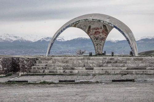 : . Bus Stop at the outskirts of Dushanbe, the city is in the valley behind the structure. Image by 