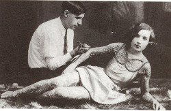  A woman being tattooed, early 1900s. 