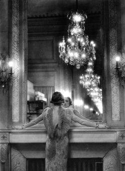 frenchvintagegallery:   Model in ostrich feather-trimmed gown pausing to regard herself in grand mirror of the Molyneux atelier. Paris, France, 1934   by   Alfred Eisenstaedt   