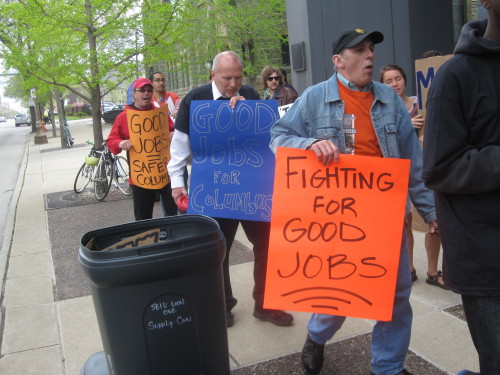 Columbus janitors, security officers and community members rallied on Monday to call on business lea