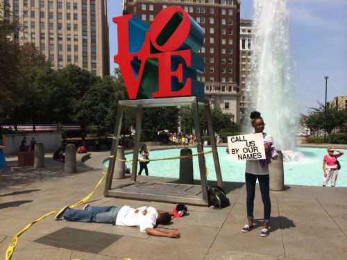 thatblackveganguy:  ras-al-ghul-is-dead:  A silent protest in Love Park, downtown Philadelphia orchestrated by performance artists protesting the murder of Michael Brown in Ferguson. The onslaught of passerby’s  wanting to take photos with the statue