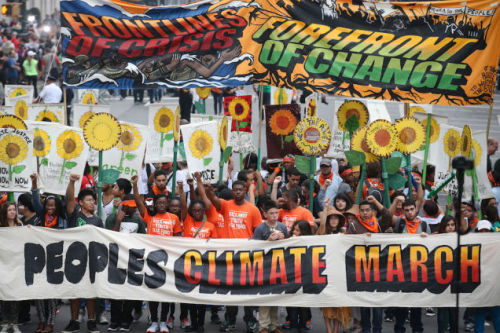 “More than 100,000 people march through midtown Manhattan on Sunday, Sept. 21, 2014 as part of the People’s Climate March, a worldwide mobilization calling on world leaders meeting at the UN to commit to urgent action on climate change and 100% clean...