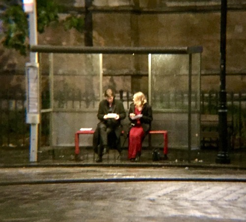 constancecream:Sherlock and the woman in red inside the bus stop.Eating fish and chips, talking, dis