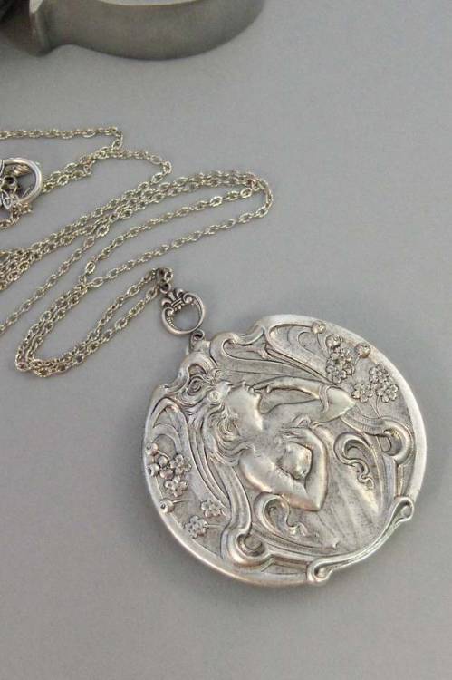 sixpenceee:This antique silver locket has a beautiful woodland goddess smelling her woodland flowers