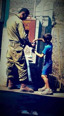 eretzyisrael:  You won’t see this on the news!  This IDF soldier gives a cool glass of water to a Palestinian child, suffering in the scorching heat. This is how the IDF helps all people — please share!   The Israel Project  