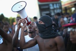 palmtreec:  Demonstrators protest the killing of teenager Michael Brown in Ferguson, Mo. on August 12, 2014.