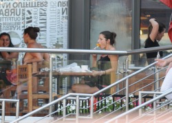 I see this cute girl eating at on of the outdoor restaurants.