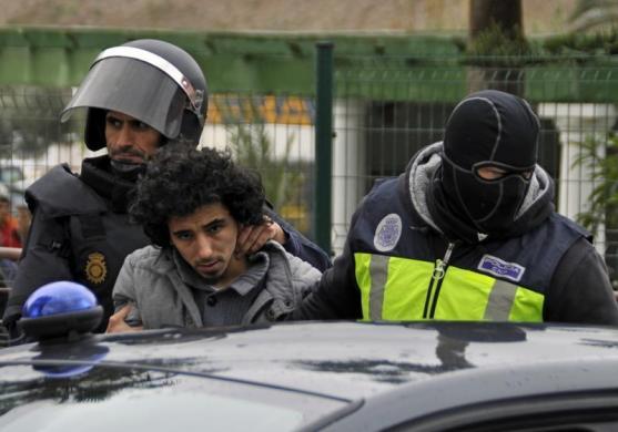 Melilla, Spain
Masked Spanish National Police officers detain a man suspected to be a member of an Islamist militant cell (via Reuters)