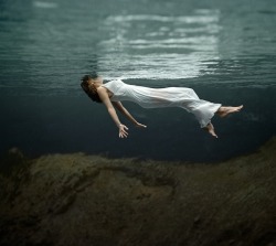 nighthawk-postcards:  Toni Frissell: A model floating in the water at Weeki Wachee Spring, Florida. Published in Harper’s Bazaar in December 1947. Originally black + white, colorized by Michael Catanachapodaca in 2012. 