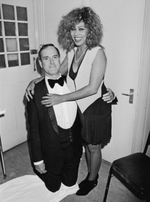 my-retro-vintage:English comic actor John Cleese with American singer Tina Turner at a party to cele