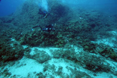 Divers search among the wreckage of one of 22 ancient shipwrecks found in 2015 around the Greek isla