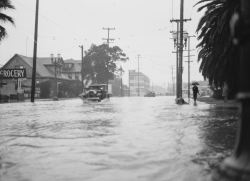 yesterdaysprint:   Rain-flooded city street,