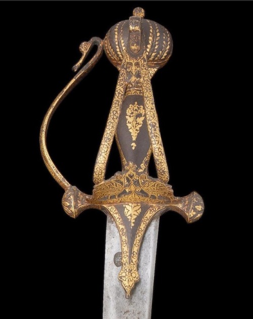 Indian Tulwar with Complex Hilt, 18th or 19th CenturyThe single-edged watered steel blade of curved 