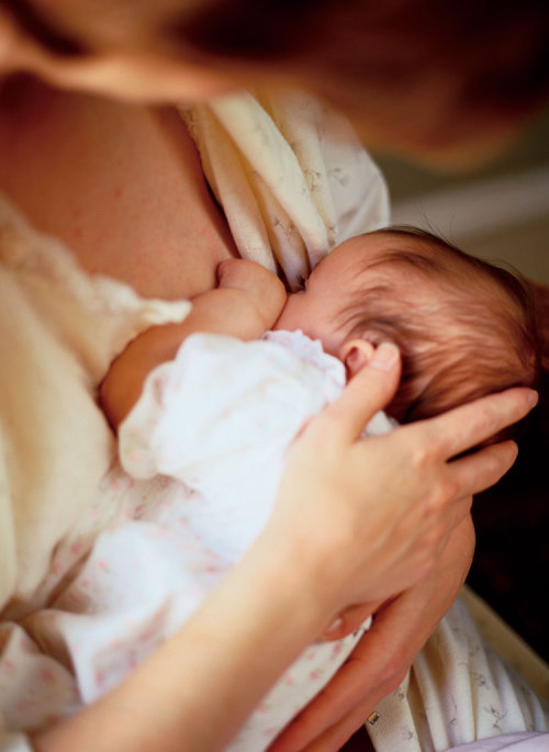 Black mother breastfeeding baby