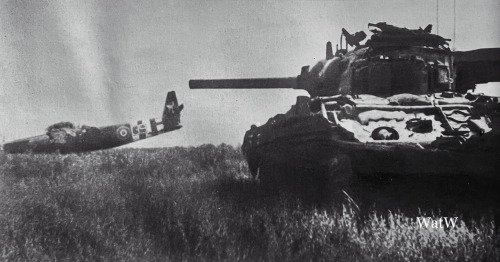 A British Sherman Duplex Drive (DD) Tank Advances Towards A Horsa Glider - Normandy, June 1944 (Note