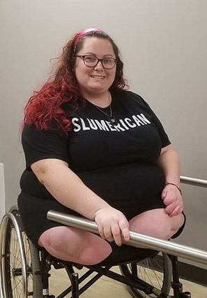 Very plump DAK bulging from the sides of her wheelchair